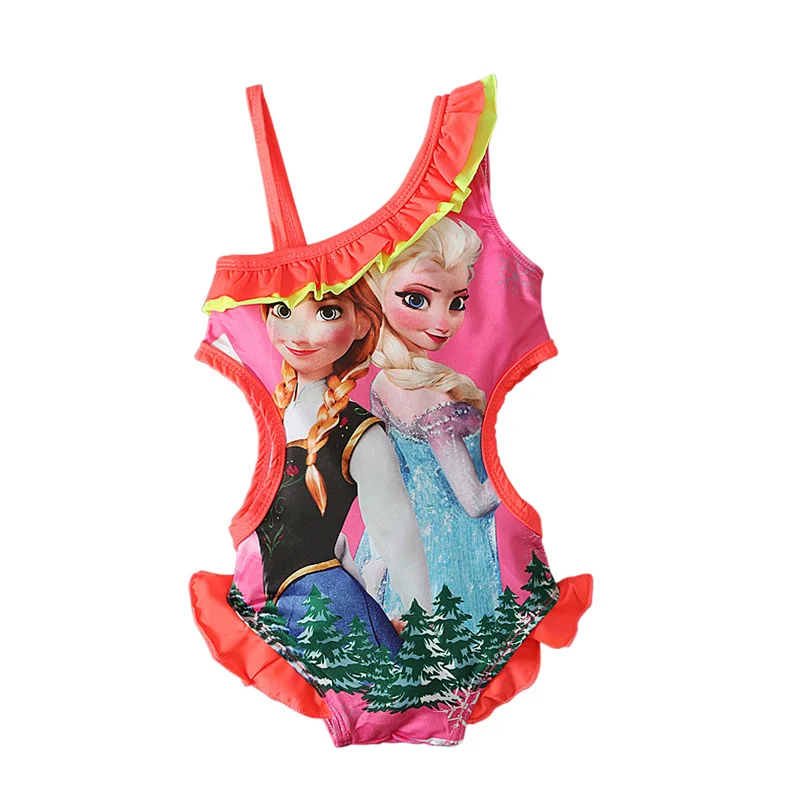 On voit un maillot de bain rose sur fond blanc qui représente les princesses de La reine des Neiges : Elsa et Anna.